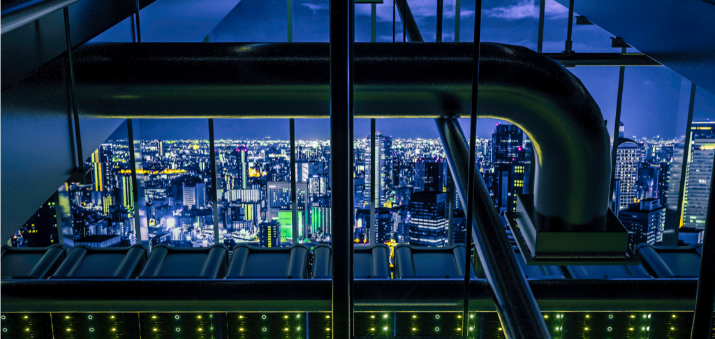 Noedra Shield key visual — illuminated city grid at night, seen from within energy infrastructure